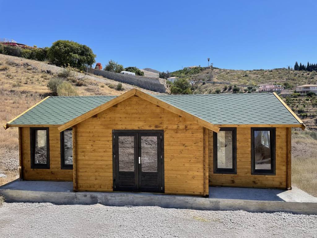 Log house with bitumen roof